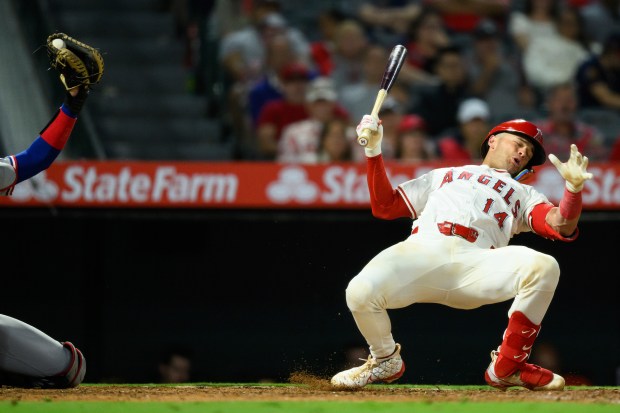 The Angels’ Logan O’Hoppe, right, reacts after dodging an inside...
