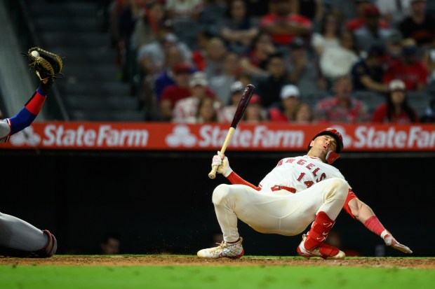 The Angels’ Logan O’Hoppe, right, reacts after dodging an inside...