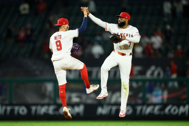 Angels center fielder Jo Adell, right, and shortstop Zach Neto...