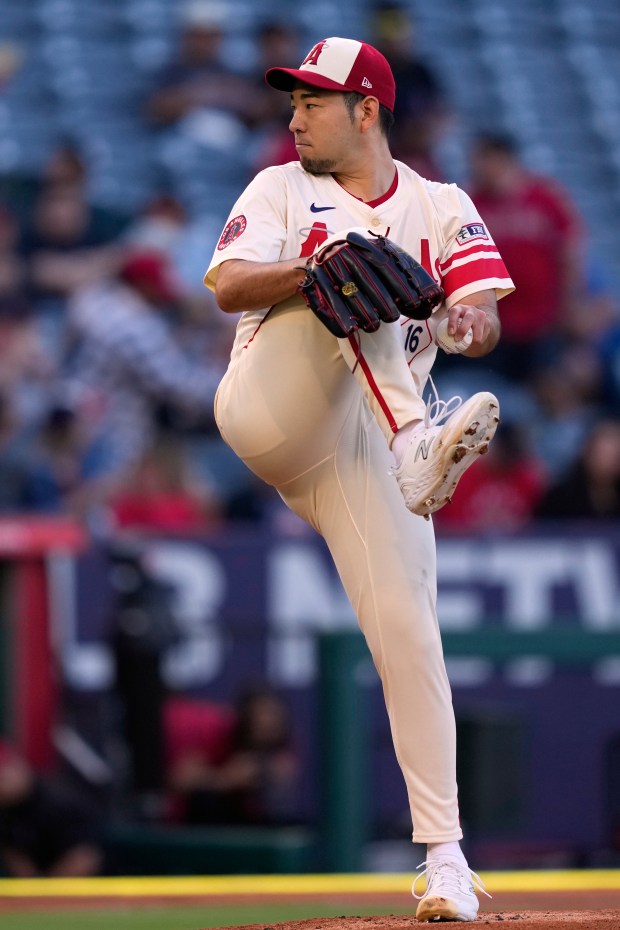 Angels starting pitcher Yusei Kikuchi throws to the plate during...