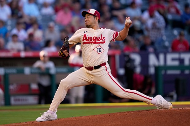 Angels starting pitcher Yusei Kikuchi throws to the plate during...