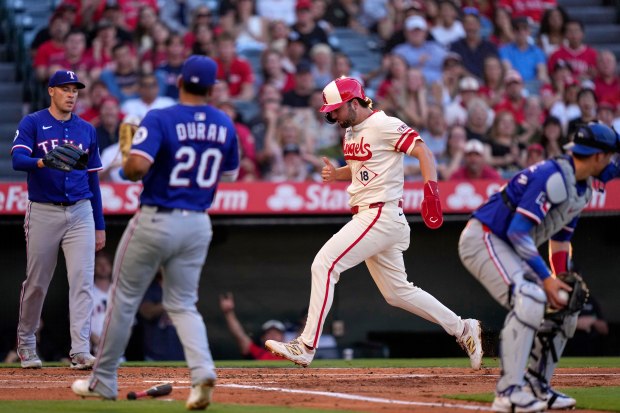 The Angels’ Nolan Schanuel, second from right, scores on a...