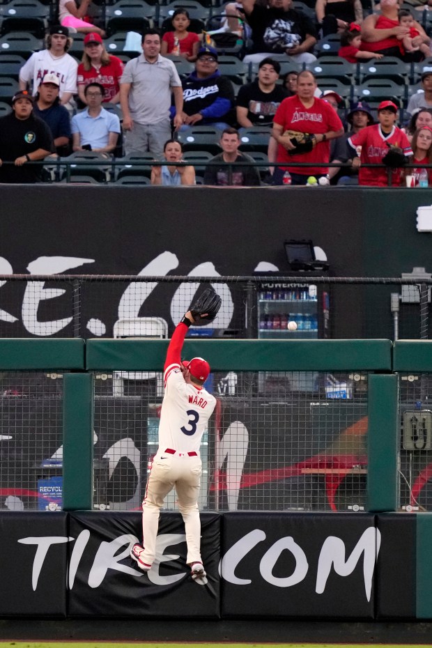 Angels left fielder Taylor Ward can’t get to a ball...