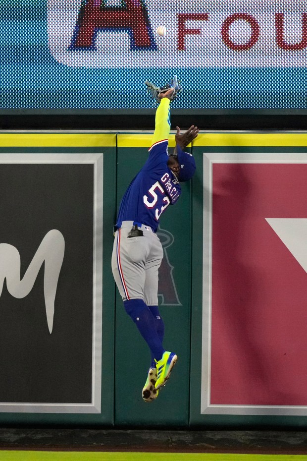Texas Rangers right fielder Adolis Garcia makes a catch on...