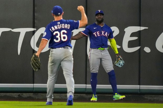 Texas Rangers right fielder Adolis Garcia, right, celebrates with center...