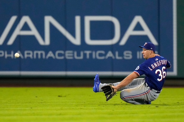 Texas Rangers center fielder Wyatt Langford can’t handle a ball...
