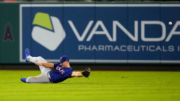 Texas Rangers center fielder Wyatt Langford can’t handle a ball...
