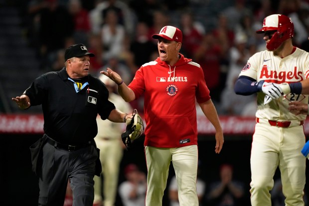 Angels interim manager Ray Montgomery, center, yells toward the Texas...