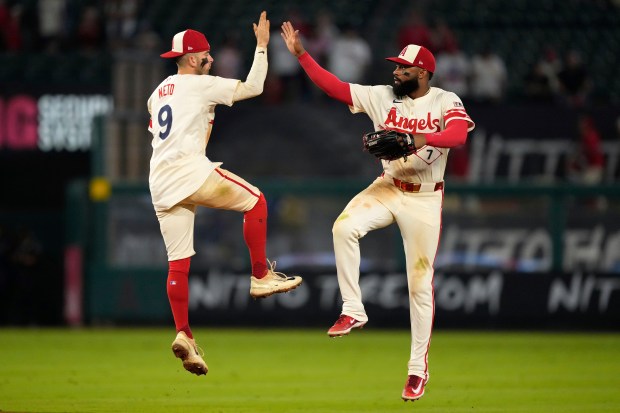 Angels shortstop Zach Neto, left, and center fielder Jo Adell...