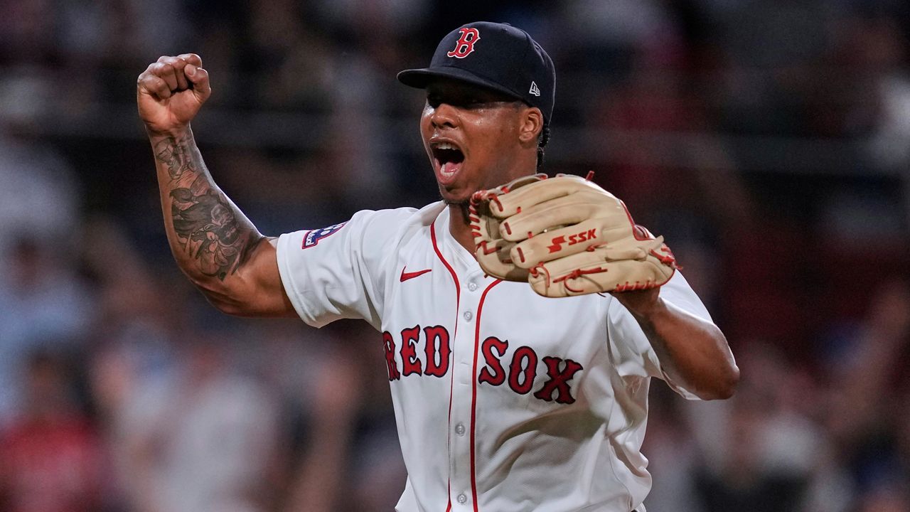 Boston Red Sox pitcher Brayan Bello celebrates after getting the win, throwing a complete game against the Colorado Rockies after a baseball game at Fenway Park, Tuesday, July 8, 2025, in Boston. (AP Photo/Charles Krupa)