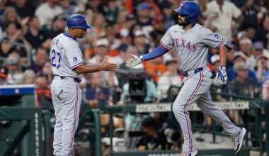 Texas Rangers' Marcus Semien, right, celebrates with third base coach Tony Beasley after hitting a home run against the Houston Astros during the eighth inning of a baseball game Sunday, July 13, 2025, in Houston. (AP Photo/David J. Phillip)