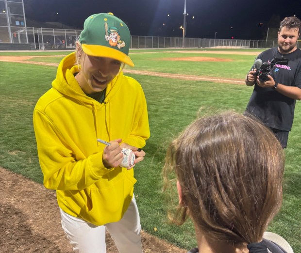 Dublin Leprechauns pitcher Marika Lyszczyk signs an autograph at a game in June 2025. (Photo courtesy of Dublin Leprechauns)