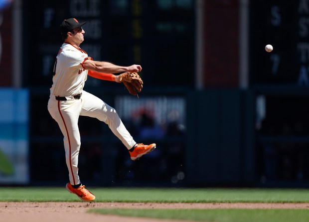 San Francisco Giants’ Casey Schmitt (10) throws to first base...