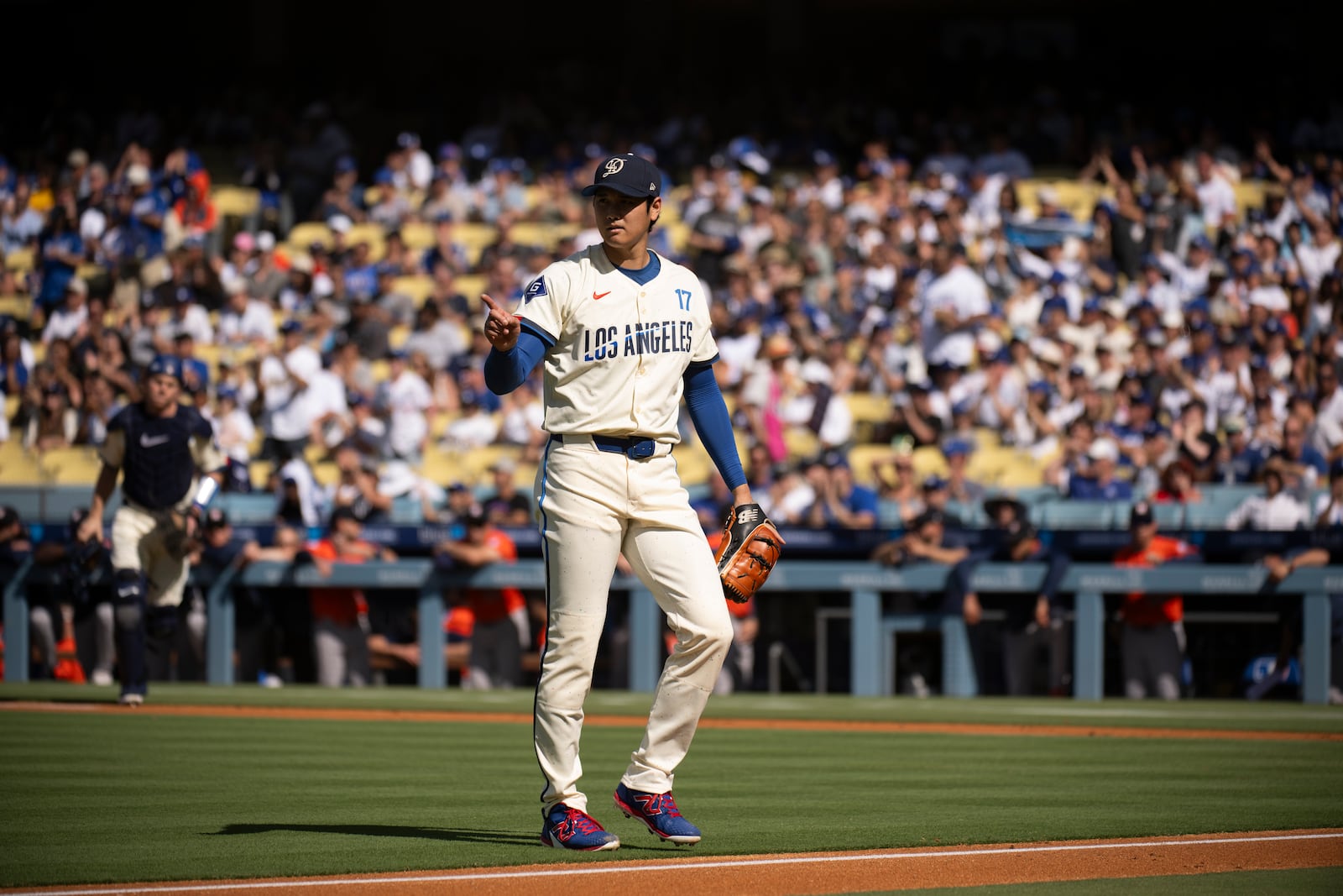 Los Angeles Dodgers starting pitcher Shohei Ohtani gestures during the first inning of a baseball game against the Houston Astros in Los Angeles, Saturday, July 5, 2025. (AP Photo/Kyusung Gong)
