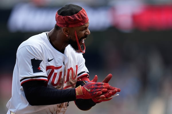 Minnesota Twins' Byron Buxton (25) celebrates after hitting a triple during the second inning of a baseball game against the Pittsburgh Pirates, Saturday, July 12, 2025, in Minneapolis. (AP Photo/Abbie Parr)