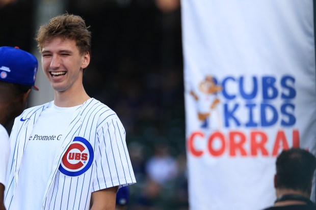 Bulls forward Matas Buzelis laughs with friends during batting practice before a Cubs-Red Sox game on July 19, 2025, at Wrigley Field. (John J. Kim/Chicago Tribune)