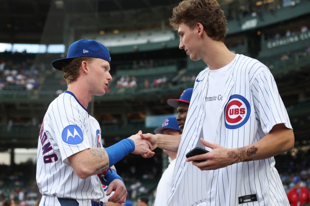 Cubs center fielder Pete Crow-Armstrong and Bulls forward Matas Buzelis greet each other before a Cubs-Red Sox game on July 19, 2025, at Wrigley Field. (John J. Kim/Chicago Tribune)