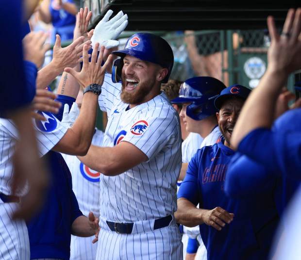 Cubs first baseman Michael Busch celebrates with teammates after hitting a home run against the Red Sox in the first inning on July 19, 2025, at Wrigley Field. (John J. Kim/Chicago Tribune)