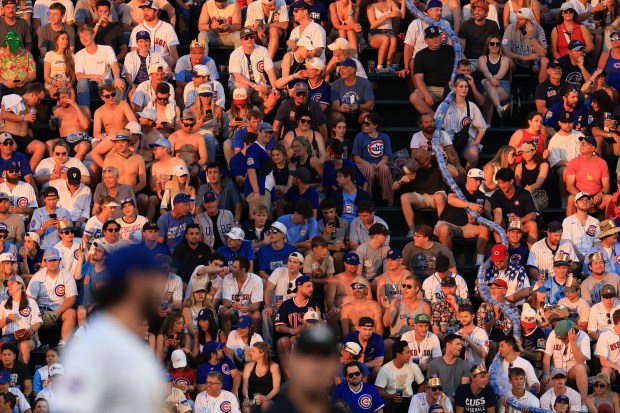 The sun sets on the right-field bleachers in the seventh inning of a Cubs-Red Sox game at Wrigley Field on July 19, 2025. (John J. Kim/Chicago Tribune)