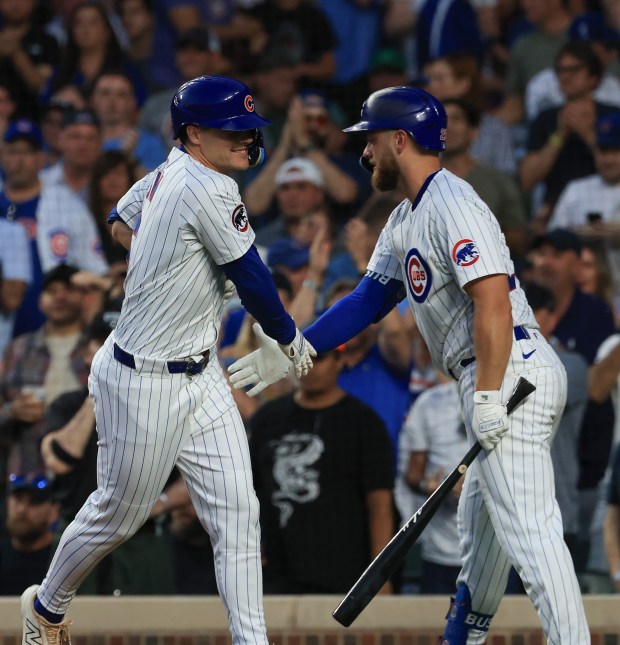 Cubs pinch hitter Matt Shaw, left, is congratulated after hitting a home run in the seventh inning against the Red Sox on July 19, 2025, at Wrigley Field. (John J. Kim/Chicago Tribune)