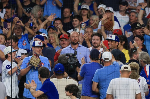 Former Cubs pitcher Jon Lester, center, is applauded by fans in the eighth inning of a Cubs-Red Sox game on July 19, 2025, at Wrigley Field. (John J. Kim/Chicago Tribune)