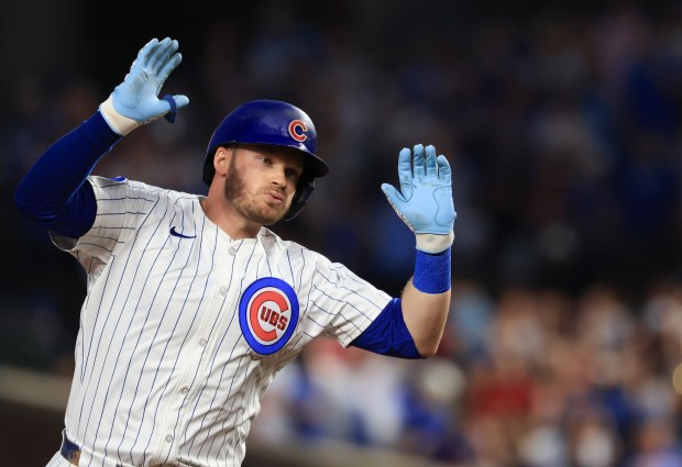 Cubs left fielder Ian Happ gestures while rounding the bases after hitting a home run in the eighth inning against the Red Sox on July 19, 2025, at Wrigley Field. (John J. Kim/Chicago Tribune)