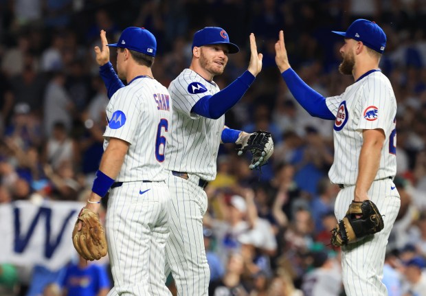 Cubs left fielder Ian Happ, center, and teammates celebrate a 6-0 win over the Red Sox on July 19, 2025, at Wrigley Field. (John J. Kim/Chicago Tribune)