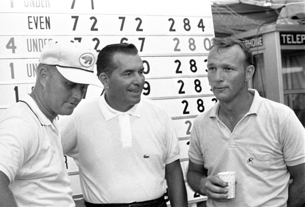 Facing a playoff for the Western Open Golf championship are, from left: Jack Nicklaus, Julius Boros and Arnold Palmer who stand in front of scoreboard at Beverly Country Club in Chicago, July 28, 1963, after finishing in a three-way tied at 280. Palmer was tied with Sam Snead in a four-stroke lead at start of play. Nicklaus shot a brilliant 66 to overcome a 7-stroke deficit. (Larry Stoddard/AP)