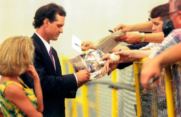 Ryne Sandberg, with wife Cindy, signs autographs outside Wrigley Field on June 13, 1994, after he announced his retirement from baseball. (Nancy Stone/Chicago Tribune)