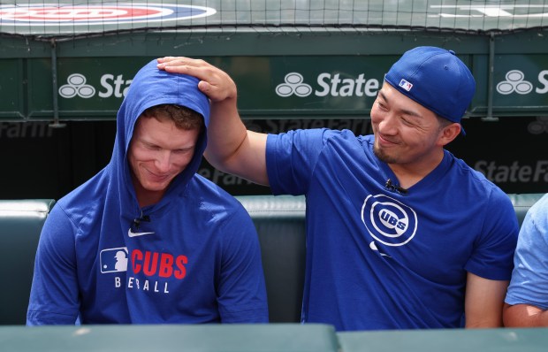 Cubs center fielder Pete Crow-Armstrong, left, gets a pat on the head from right fielder Seiya Suzuki during an interview before a game against the Cardinals at Wrigley Field on July 6, 2025, in Chicago. (John J. Kim/Chicago Tribune)