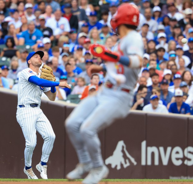 Chicago Cubs second baseman Nico Hoerner throws to first on an infield single from Cardinals first baseman Willson Contreras as Cardinals shortstop Masyn Winn heads to second in the first inning at Wrigley Field on July 6, 2025, in Chicago. (John J. Kim/Chicago Tribune)