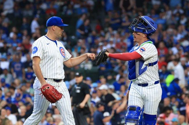 Cubs starting pitcher Matthew Boyd, left, and catcher Reese McGuire share a fist bump after the top of the third inning against the Cardinals at Wrigley Field on July 6, 2025, in Chicago. (John J. Kim/Chicago Tribune)