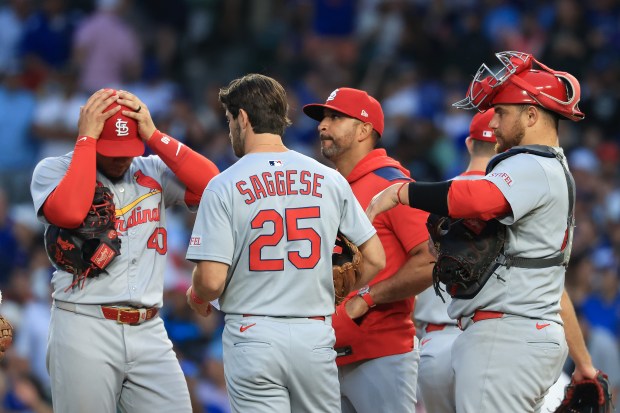 Cardinals manager Oliver Marmol, center right, stands on the mound during a pitching change in the third inning against the Cubs at Wrigley Field on July 6, 2025, in Chicago. (John J. Kim/Chicago Tribune)
