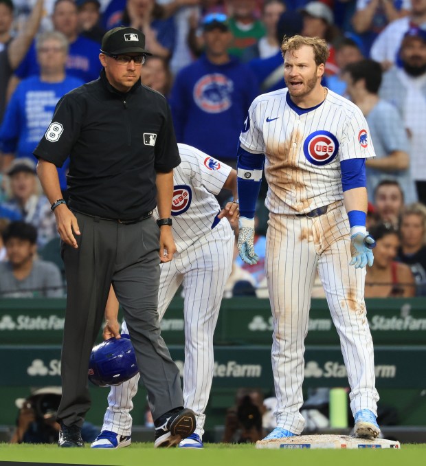 Cubs left fielder Ian Happ, right, argues with first base umpire Adam Hamari after being called on a groundout in the third inning against the Cardinals at Wrigley Field on July 6, 2025, in Chicago. (John J. Kim/Chicago Tribune)