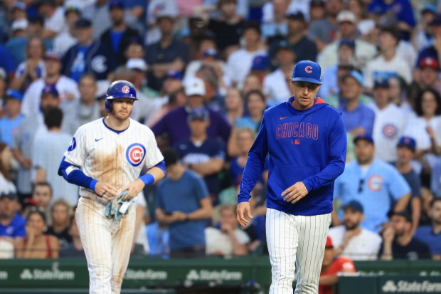 Cubs manager Craig Counsell, right, and left fielder Ian Happ head to the dugout after Happ is called on a groundout in the third inning against the Cardinals at Wrigley Field on July 6, 2025, in Chicago. (John J. Kim/Chicago Tribune)