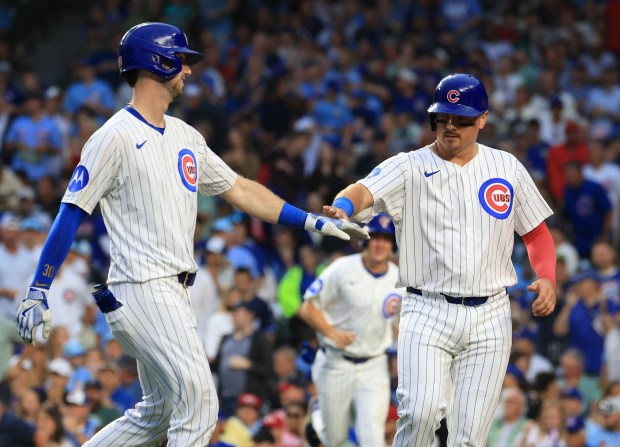 Cubs left fielder Kyle Tucker, left, is congratulated by catcher Reese McGuire on an RBI sacrifice fly ball in the third inning against the Cardinals at Wrigley Field on July 6, 2025, in Chicago. (John J. Kim/Chicago Tribune)
