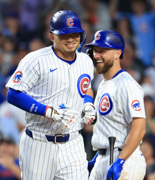 Cubs designated hitter Seiya Suzuki, left, is congratulated by first baseman Michael Busch after hitting a home run in the fifth inning against the Cardinals on Sunday, July 6, 2025, at Wrigley Field. (John J. Kim/Chicago Tribune)