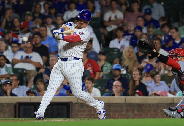 Cubs catcher Reese McGuire swings for a single in the sixth inning against the Cardinals at Wrigley Field on July 6, 2025, in Chicago. (John J. Kim/Chicago Tribune)