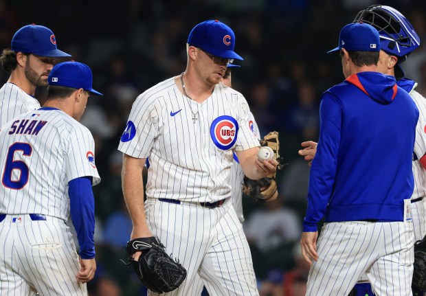 Cubs pitcher Jordan Wicks hands manager Craig Counsell the ball as he is taken out of the game in the ninth inning against the Cardinals at Wrigley Field on July 6, 2025, in Chicago. (John J. Kim/Chicago Tribune)