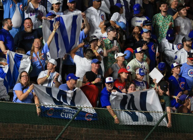 Fans celebrate an 11-0 Cubs win over the Cardinals at Wrigley Field on July 6, 2025, in Chicago. (John J. Kim/Chicago Tribune)