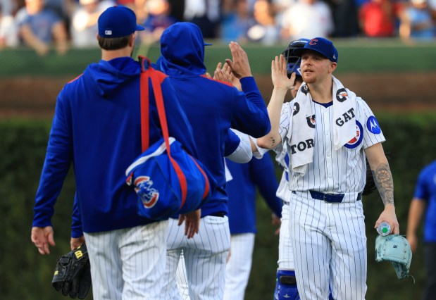 Cubs starting pitcher Cade Horton, right, high-fives teammates after warming up for a game against the Guardians at Wrigley Field on July 3, 2025, in Chicago. (John J. Kim/Chicago Tribune)