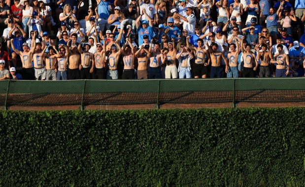 Fans of Cubs center fielder Pete Crow-Armstrong wear body paint spelling out his name before a game against the Guardians at Wrigley Field on July 3, 2025, in Chicago. (John J. Kim/Chicago Tribune)