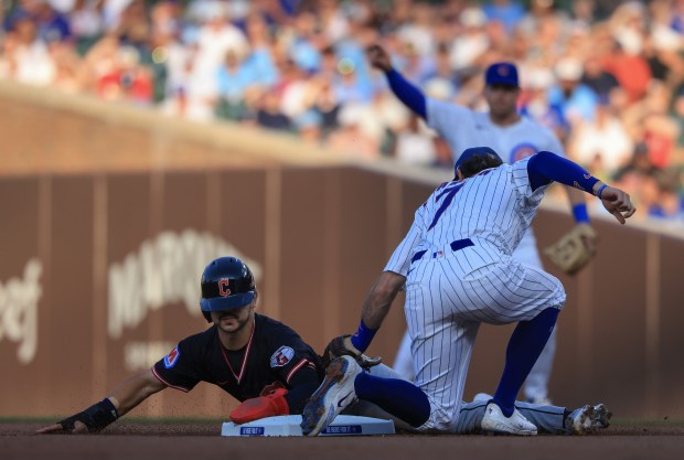 Cubs shortstop Dansby Swanson (7) tags out Guardians left fielder Steven Kwan on a steal attempt in the first inning at Wrigley Field on July 3, 2025, in Chicago. (John J. Kim/Chicago Tribune)