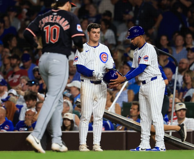Cubs third baseman Matt Shaw, center, hands off his batting helmet after lining out in the seventh inning against the Guardians at Wrigley Field on July 3, 2025, in Chicago. (John J. Kim/Chicago Tribune)