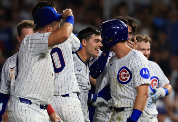 Cubs third baseman Matt Shaw, center, is congratulated after hitting a game-winning RBI sacrifice fly ball for a 1-0 win over the Guardians in ten innings at Wrigley Field on July 3, 2025, in Chicago. (John J. Kim/Chicago Tribune)