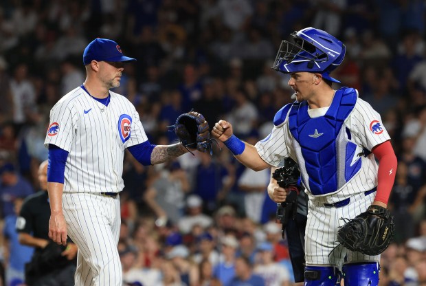 Cubs pitcher Ryan Pressly, left, is congratulated by catcher Reese McGuire after throwing the ninth inning against the Guardians at Wrigley Field on July 3, 2025, in Chicago. (John J. Kim/Chicago Tribune)
