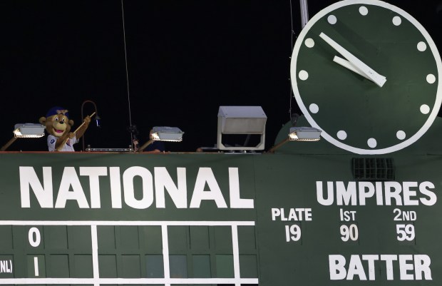 Cubs mascot Clark sweeps a broom while celebrating atop the scoreboard after a 1-0 win in ten innings against the Guardians at Wrigley Field on July 3, 2025, in Chicago. The Cubs swept the Guardians in a three-game series. (John J. Kim/Chicago Tribune)