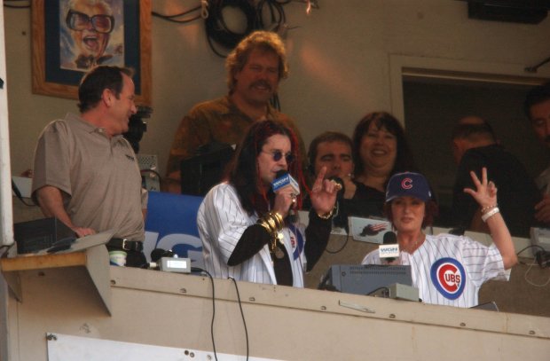 Ozzy Osbourne and his wife, Sharon, perform "Take Me Out to the Ball Game" during the seventh-inning stretch at a Cubs-Dodgers game Aug. 17, 2003, at Wrigley Field. (José M. Osorio/Chicago Tribune)