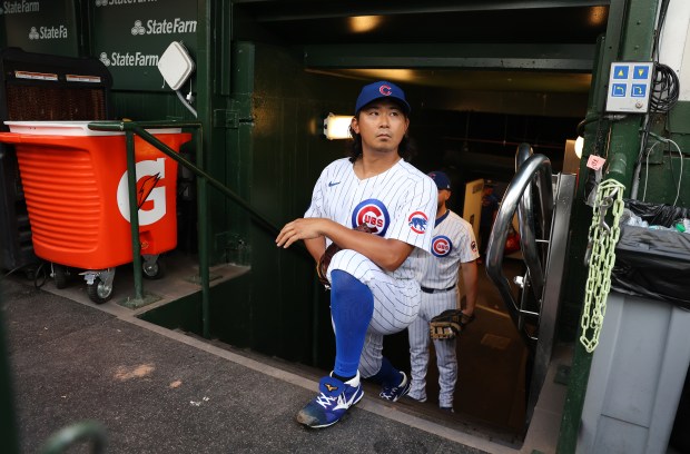 Chicago Cubs starting pitcher Shota Imanaga relaxes in the dugout before taking the field for a game of a game against the Cleveland Guardians at Wrigley Field in Chicago on July 2, 2025. (Chris Sweda/Chicago Tribune)