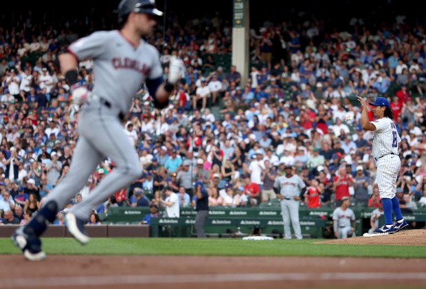 Chicago Cubs starting pitcher Shota Imanaga reacts on the mound as Cleveland Guardians outfielder Lane Thomas (left) rounds the bases after hitting a solo home run off of Imanaga in the second inning of a game at Wrigley Field in Chicago on July 2, 2025. (Chris Sweda/Chicago Tribune)